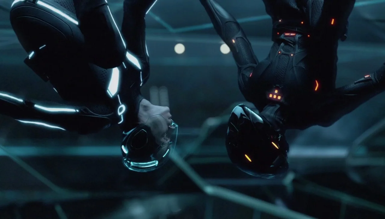 TRON: Legacy (2010) movie still: medium — Two individuals hang upside down in a dark, abstract environment with digital lighting. They wear…