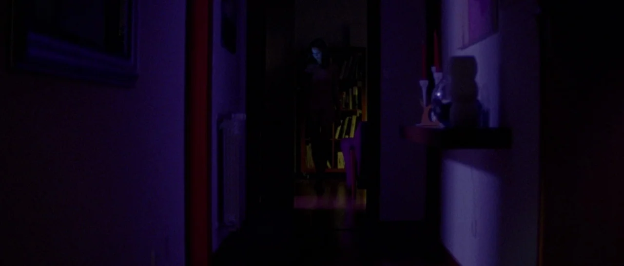 Arabian Nights: Volume 2 The Desolate One (2015) movie still: wide — A dark, narrow corridor transitions into a brightly lit room at the far end. A…