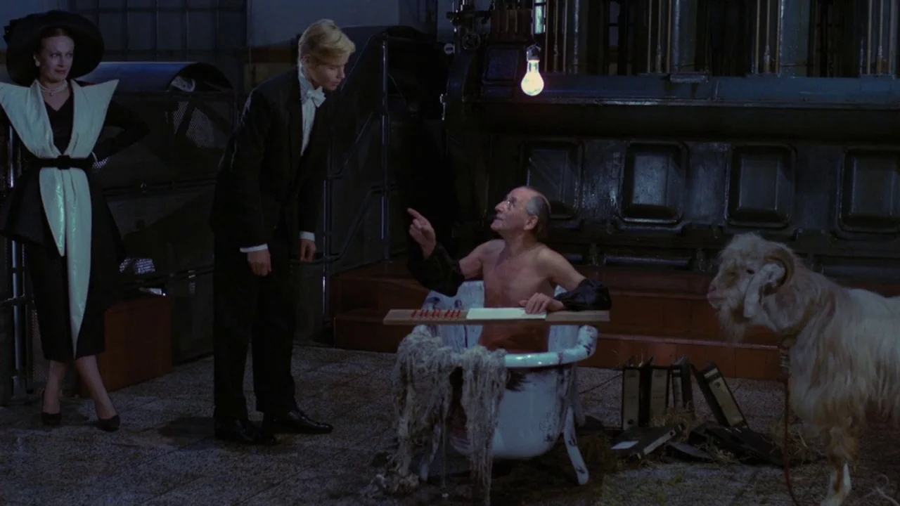 Dorian Gray in the Mirror of the Yellow Press (1984) movie still: wide — A dark, utilitarian industrial space features large machinery and stone…