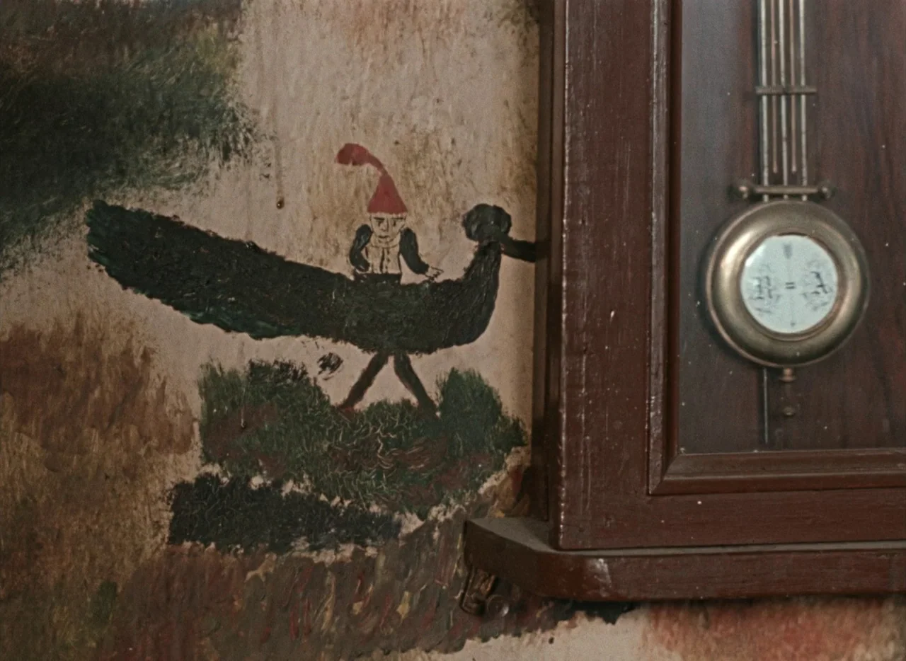 Pearls of the Deep (1965) movie still: closeup — A textured wall features a hand-painted primitive illustration of a rider on a bird. To the right,…
