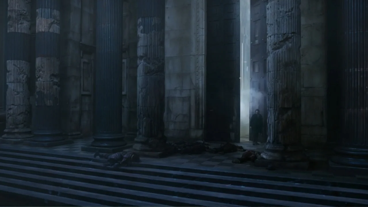 Mortal Engines (2018) movie still: wide — An ancient stone portico features massive fluted columns and a checkered marble floor. A lone dark figure…
