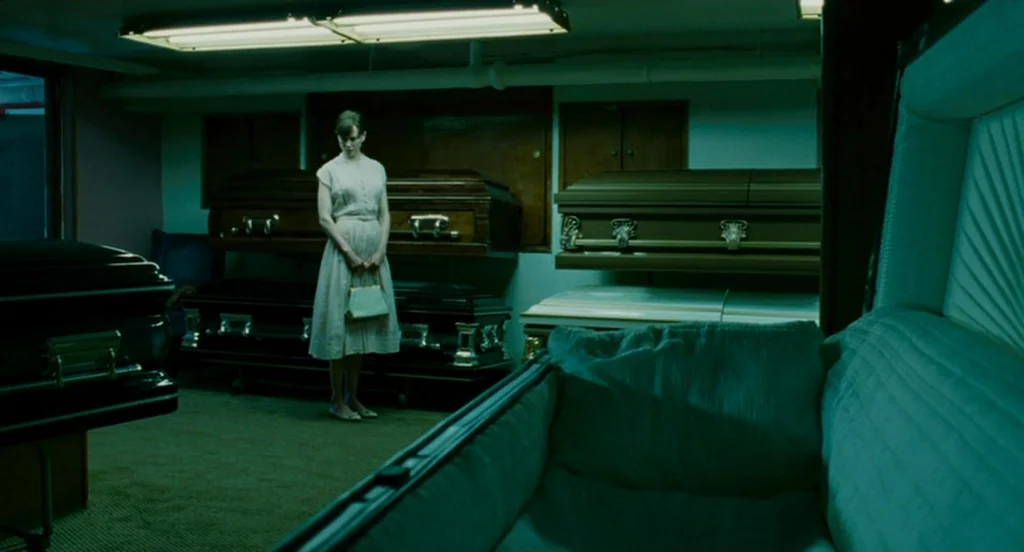 Fur: An Imaginary Portrait Of Diane Arbus (2006) movie still: fullbody — A basement room contains multiple dark wooden coffins arranged on wheeled…