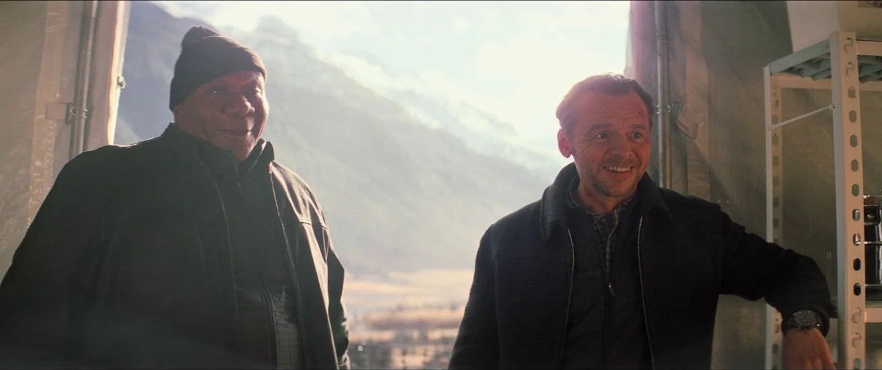 Mission: Impossible – Fallout (2018) movie still: medium — Two men stand inside a fabric tent with a large mountain range visible outside. The…