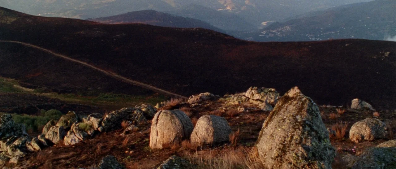 Arabian Nights: Volume 1 – The Restless One (2015) movie still: establishing — A rugged mountainside shows scorched dark earth and scattered mossy…