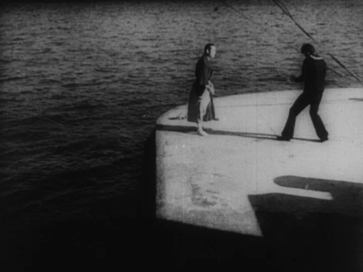 Sanshiro Sugata Part II (1945) movie still: wide — A man in robes and a man in Western clothes stand on a pier. The concrete edge extends into dark…