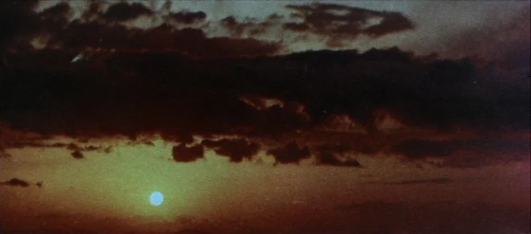 The Horrors of Malformed Men (1969) movie still: establishing — A expansive sky at dusk features dark, dense cloud formations layered over a hazy…