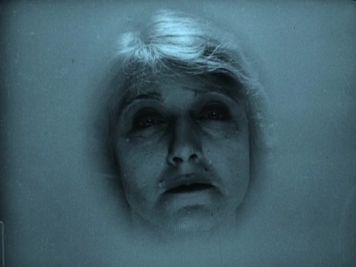Making of: The Wheel (La Roue) (1923) movie still: closeup — A woman's head rests in water within a porcelain container. The surface of the liquid…