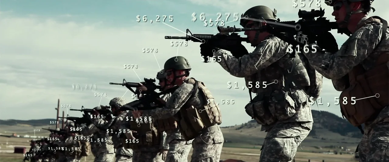 War Dogs (2016) movie still: medium — A line of soldiers wearing tactical gear aims rifles at an outdoor range. Numeric dollar values are digitally…