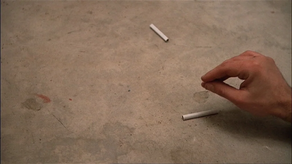 One Flew Over the Cuckoo's Nest (1975) movie still: closeup — A bare concrete floor shows slight discoloration and surface debris in an interior…