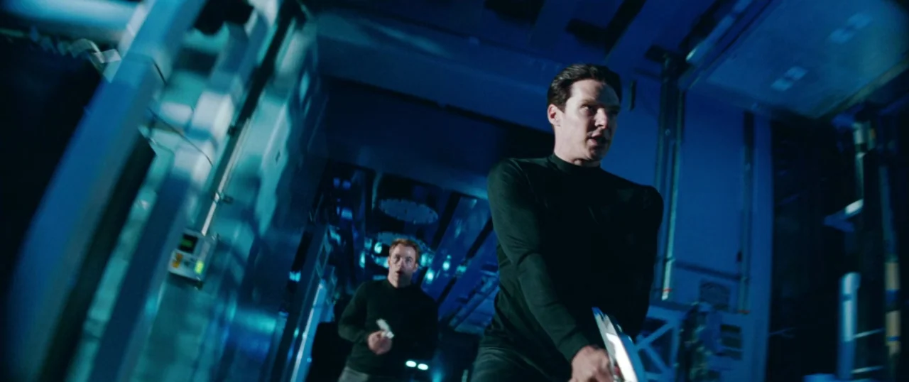 Star Trek Into Darkness (2013) movie still: medium — A narrow, metallic sci-fi corridor features glowing interface panels and complex industrial…