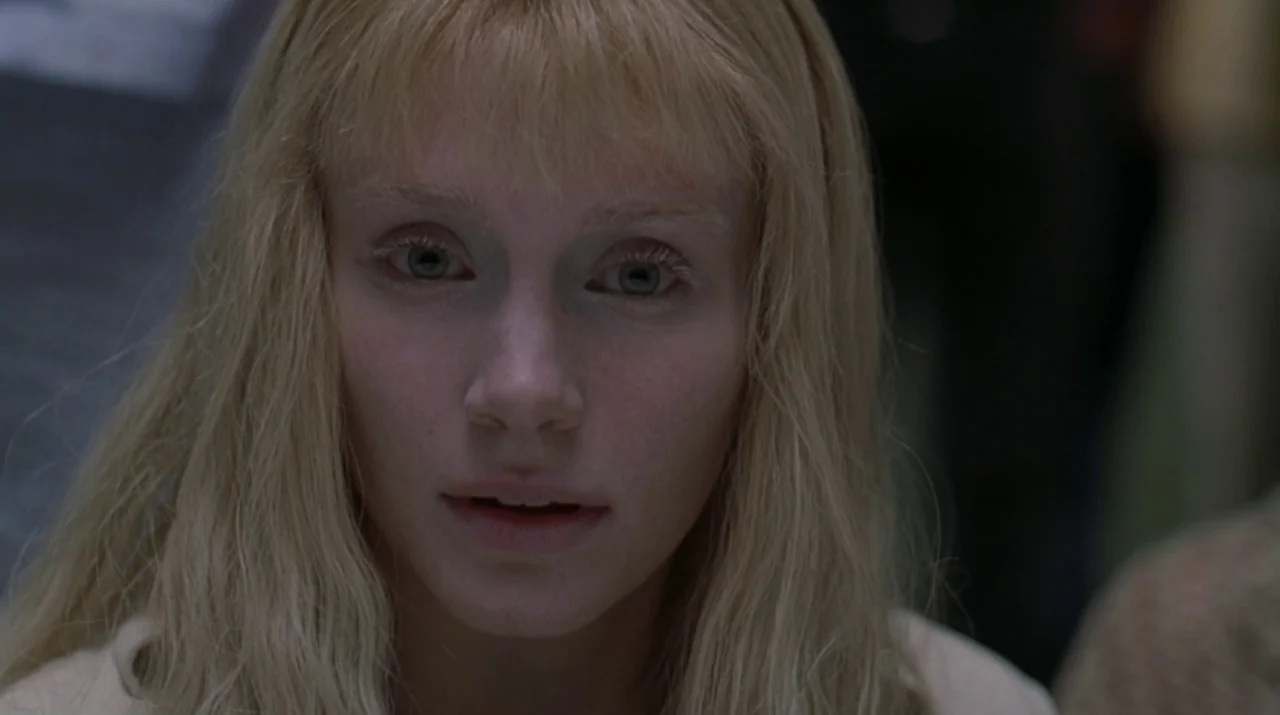Lady in the Water (2006) movie still: closeup — A close-up shot focuses on a young woman against a blurred, neutral background. She gazes ahead with…