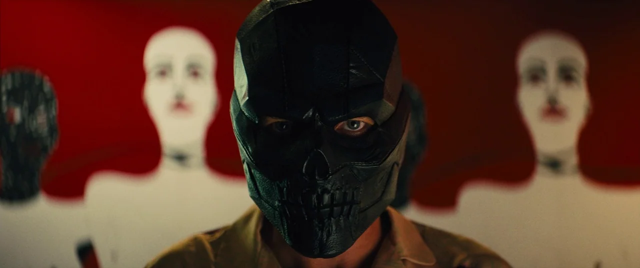 Birds of Prey (and the Fantabulous Emancipation of One Harley Quinn) (2020) movie still: closeup — A man wearing a black skull mask stands in front…