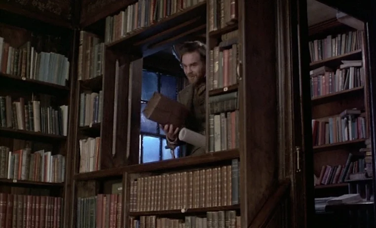 The Story of Adele H (1975) movie still: medium — A dark, wood-paneled study is filled with numerous floor-to-ceiling shelves packed with antique…