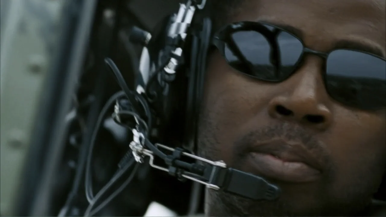 28 Weeks Later (2007) movie still: closeup — A close-up view shows the interior of a helicopter cockpit with metal structural elements. A male pilot…