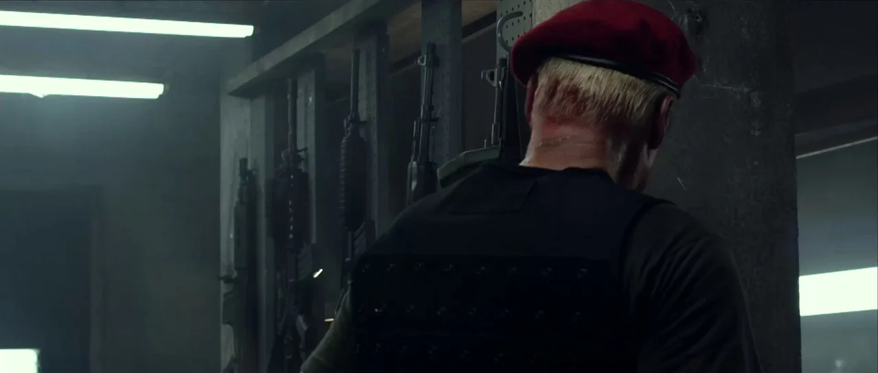 Universal Soldier: Day of Reckoning (2012) movie still: medium — A dark armory contains a metal gun rack with several rifles hung vertically. A man…