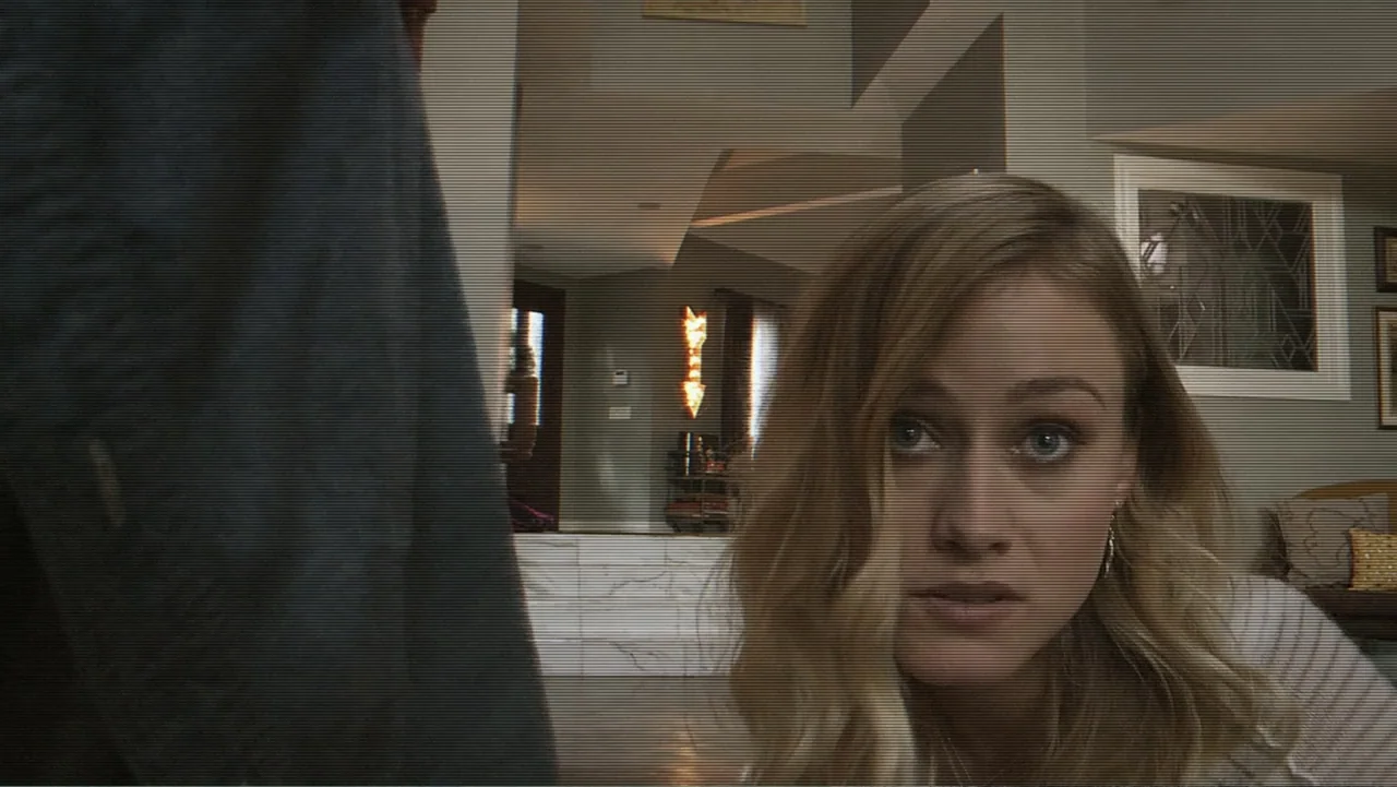 Paranormal Activity: The Ghost Dimension (2015) movie still: closeup — A modern suburban living room features an open floor plan and neutral decor.…