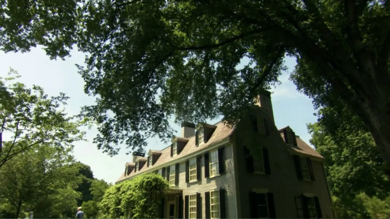 David McCullough: Painting with Words (2008) movie still: establishing — A historic colonial-style house sits nestled among lush green trees on a…