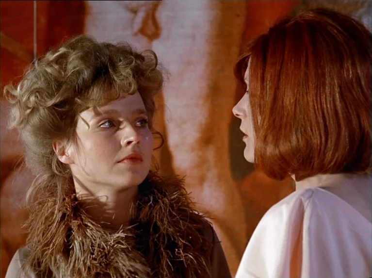 The Bitter Tears Of Petra Von Kant (1972) movie still: medium — Two women stand in front of a large painting in a gallery space. The blonde woman…