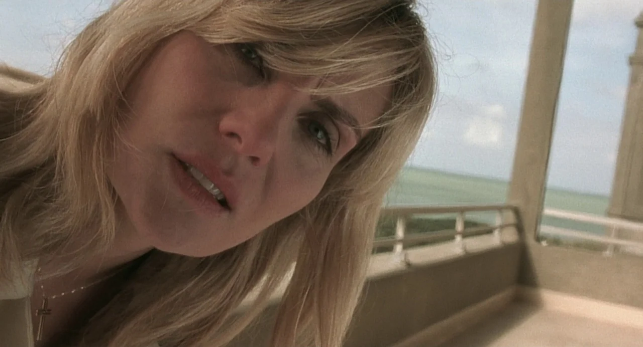 The Diving Bell and the Butterfly (2007) movie still: closeup — A sunny outdoor balcony overlooks a distant body of water under a bright sky. A…