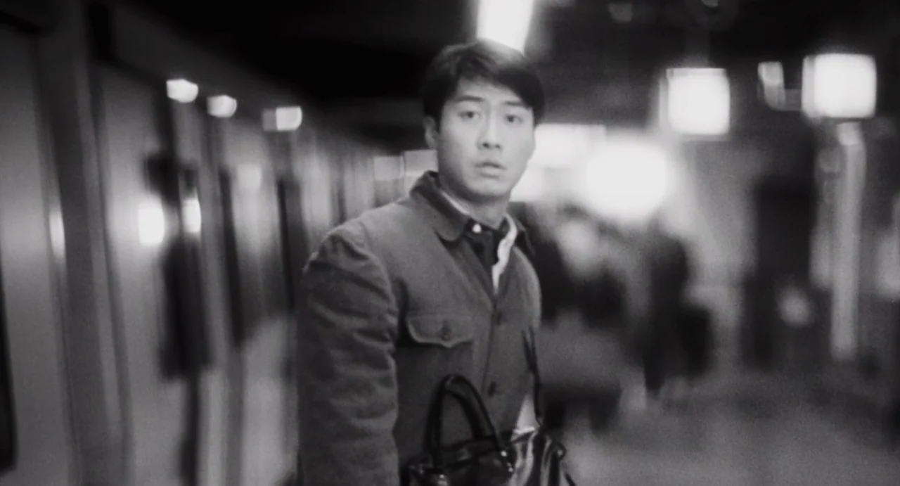 Comrades: Almost A Love Story (1996) movie still: medium — An underground transit platform features blurred industrial structural details and…