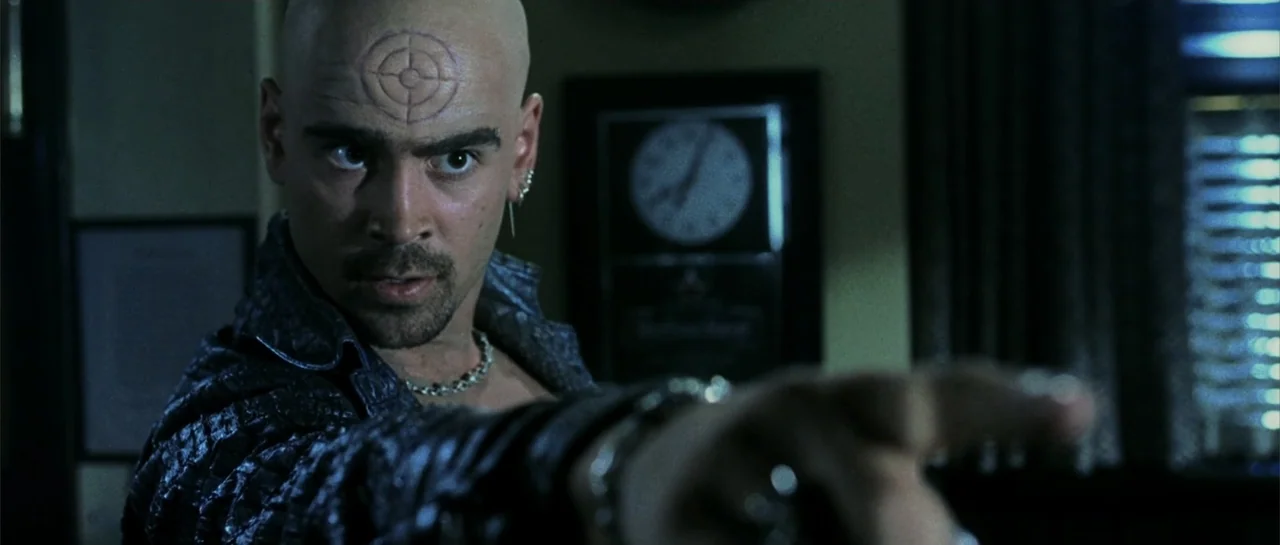 Daredevil (2015) movie still: medium — A dimly lit room contains a wall clock visible behind the subject. A bald man with a facial tattoo points his…