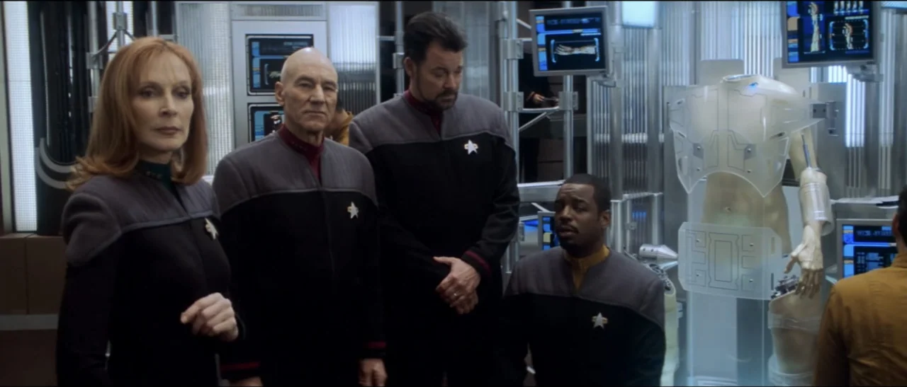 Star Trek: Nemesis (2002) movie still: medium — A futuristic laboratory filled with computer monitors and metallic equipment displays. Four crew…