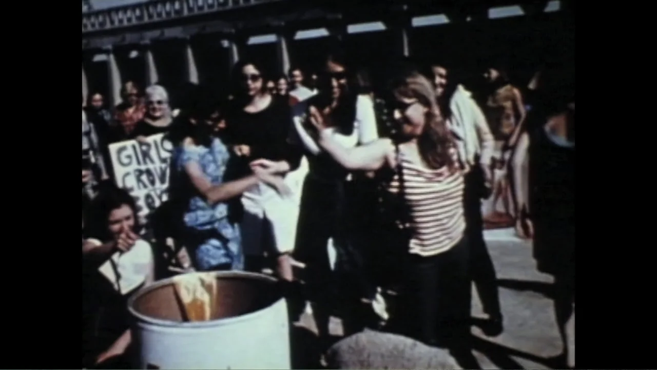 Dear Ms.: A Revolution in Print (2025) movie still: medium — A group of women gather in a public square during the day. Several individuals stand…