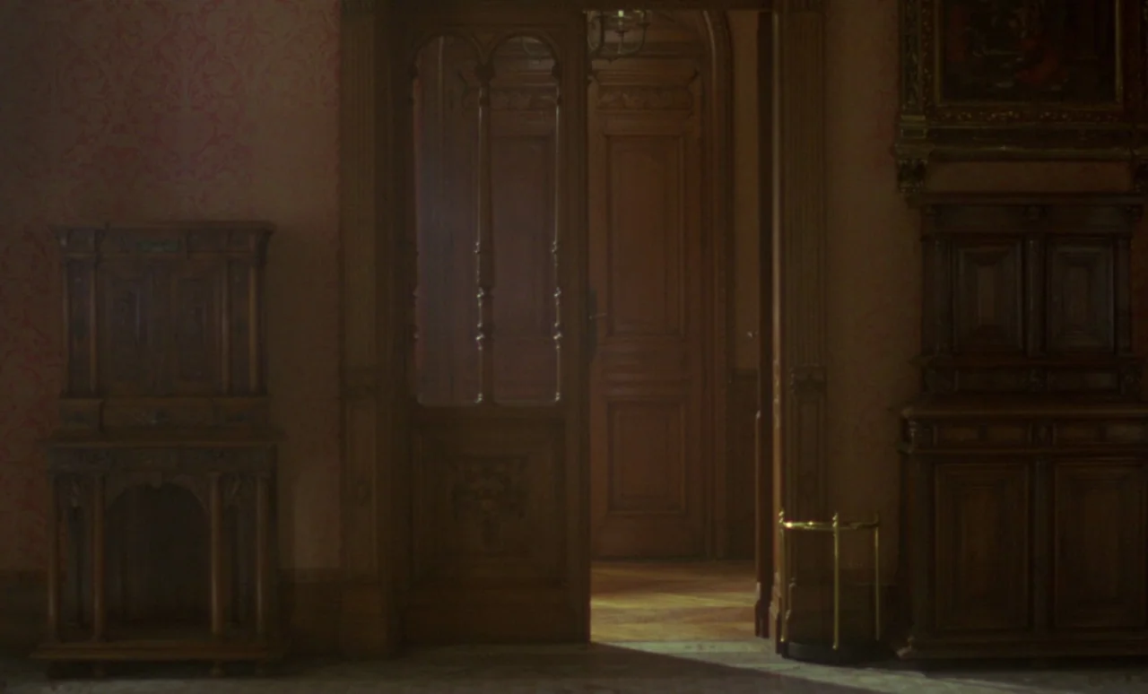 The Strange Case of Dr. Jekyll and Miss Osbourne (1981) movie still: establishing — An opulent, dim room features dark wooden cabinetry and red…