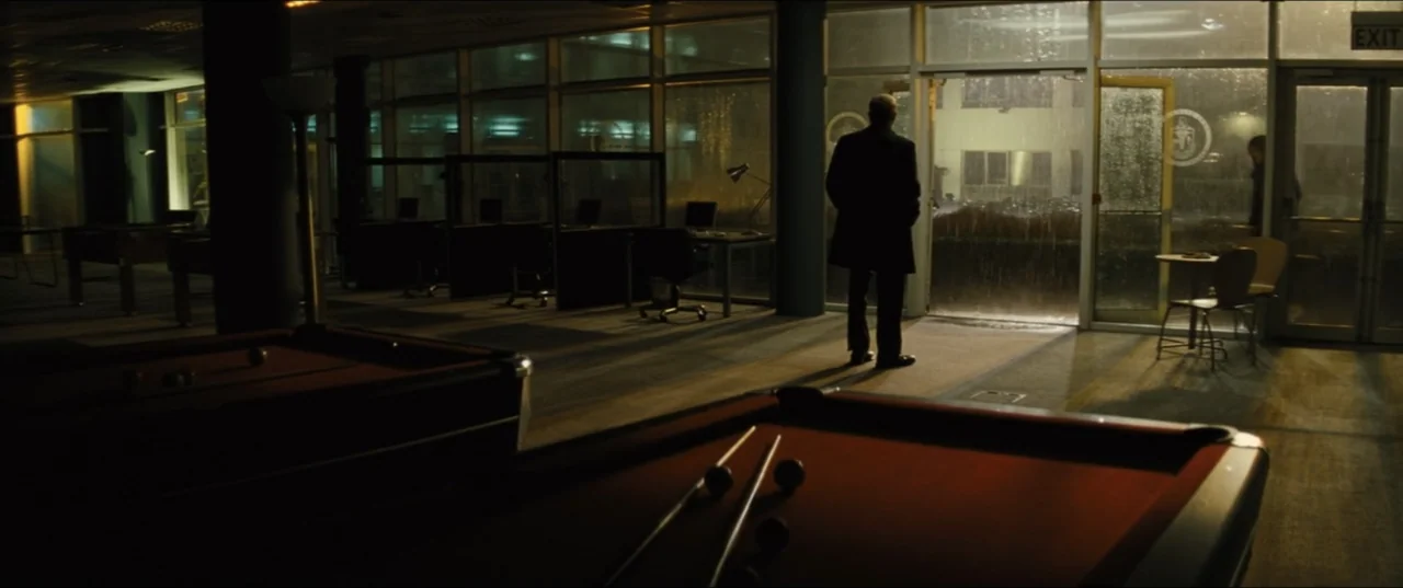 Jack Ryan: Shadow Recruit (2014) movie still: wide — A dimly lit recreation room features billiard tables and large windows facing a rainy exterior.…