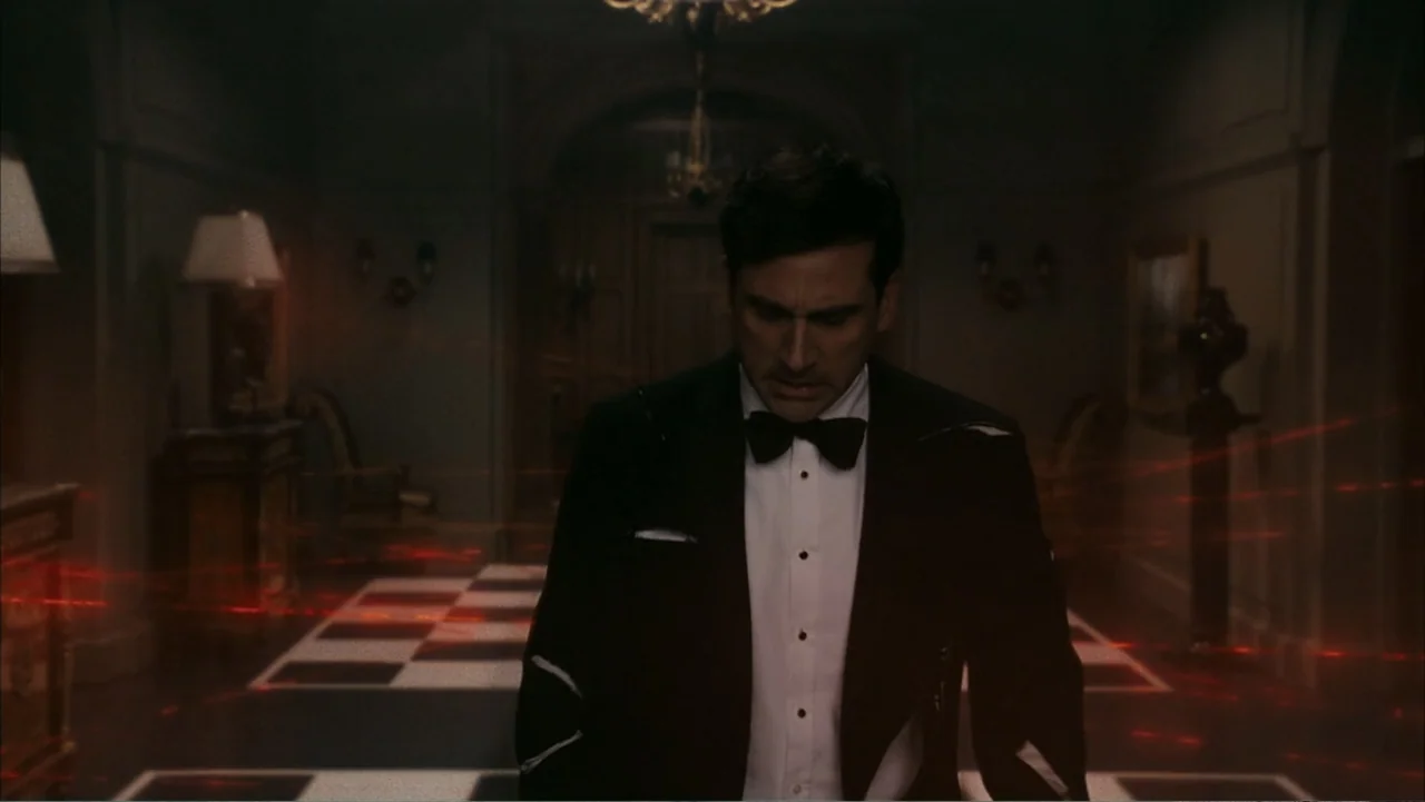 Get Smart (2008) movie still: medium — A dark mansion interior with a checkerboard floor and ornate dark wood paneling. A man in a formal black…