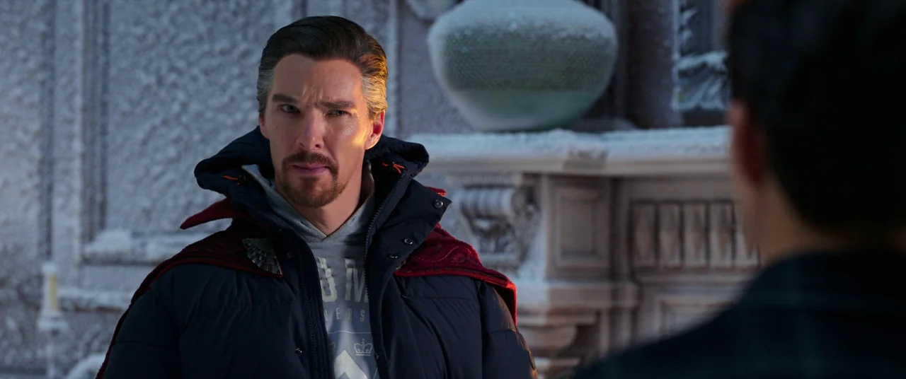 Spider-Man: No Way Home (2021) movie still: medium — An interior space covered in a thick layer of snow and ice crystals. A man in a puffy jacket…