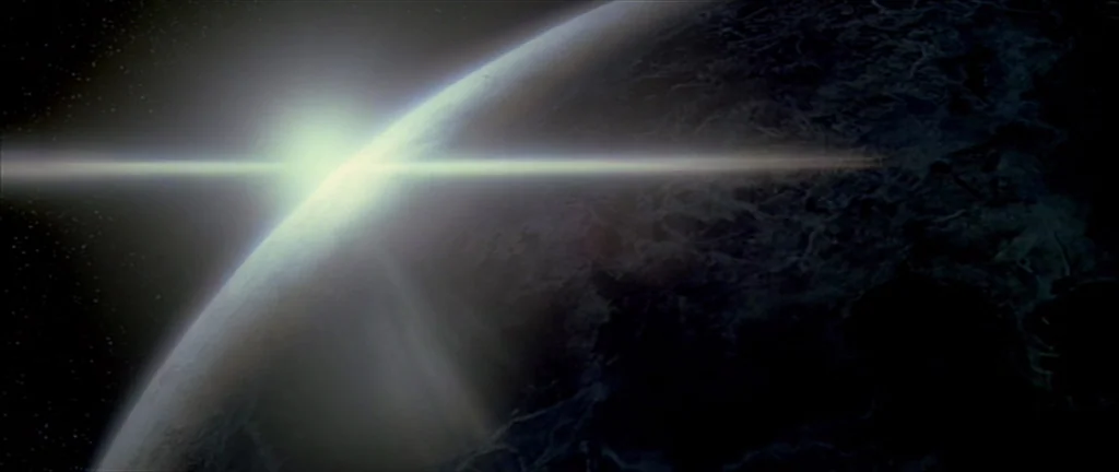 Alien 3 (1992) movie still: establishing — A dark curved planet is visible against the deep black void of outer space. A bright light source peaks…