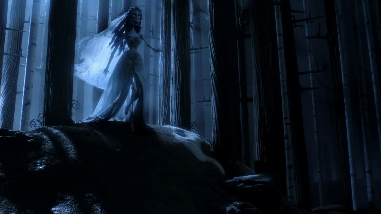 The Corpse Bride (2005) movie still: fullbody — A dark, blue-toned woodland at night features tall vertical tree trunks and sparse undergrowth. A…