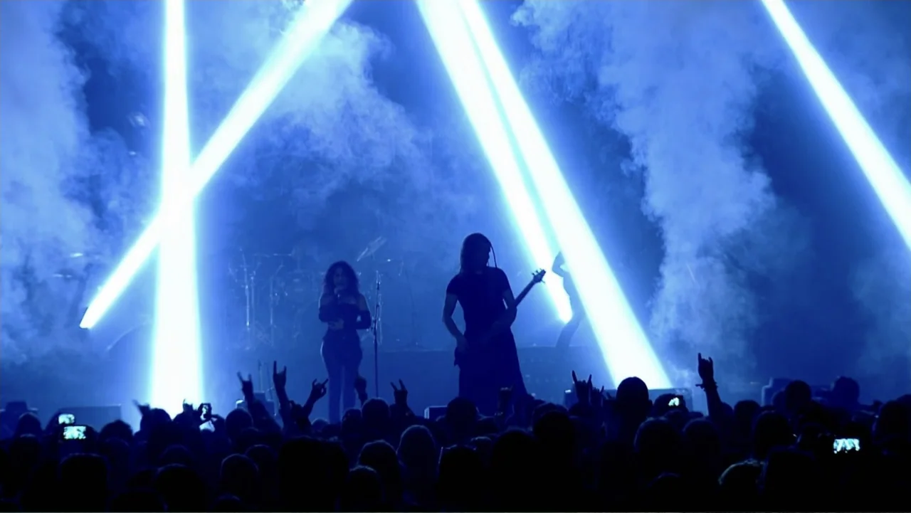 Soaring Highs and Brutal Lows: The Voices of Women in Metal (2015) movie still: fullbody — A dark concert hall filled with thick smoke and bright…
