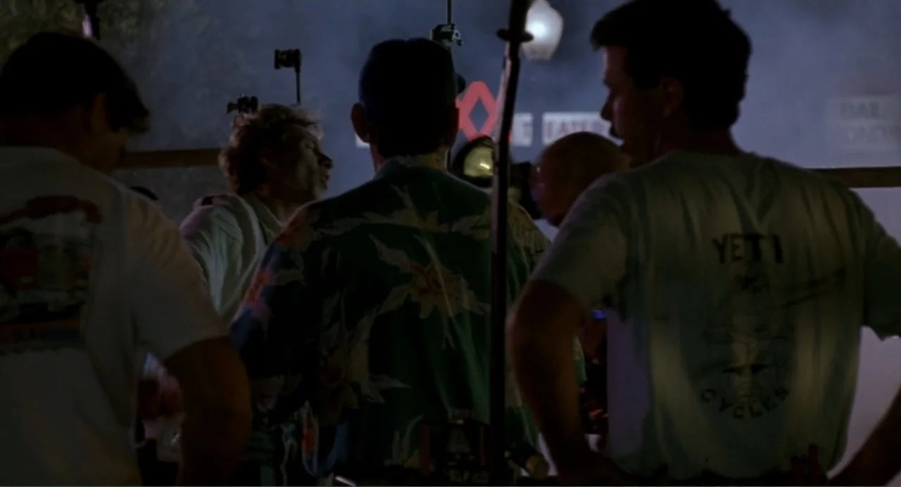 F/X2 (1991) movie still: medium — A nighttime exterior scene features a small group of men gathered in a parking lot. The men stand in a cluster…
