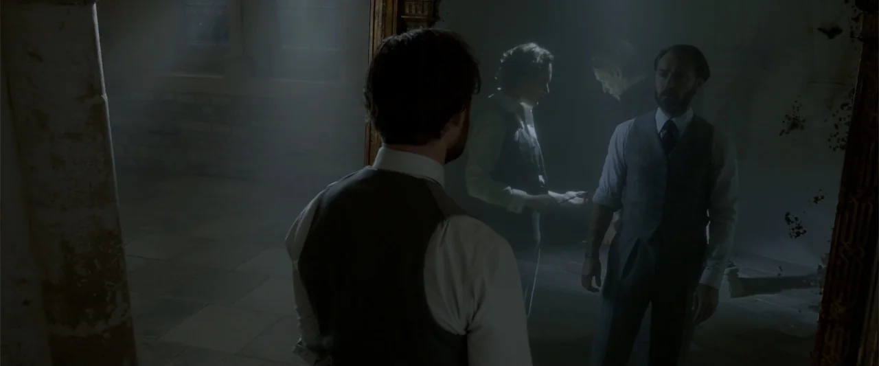Fantastic Beasts: The Crimes of Grindelwald (2018) movie still: medium — A dimly lit room with stone walls and floor is obscured by thick haze. A…
