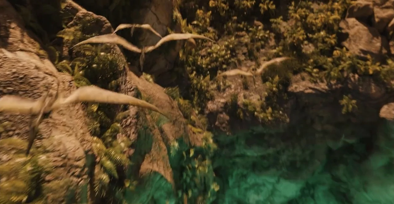 Men in Black 3 (2012) movie still: wide — A high-angle view looks down into a deep tropical canyon with sheer rock walls. Several winged creatures…