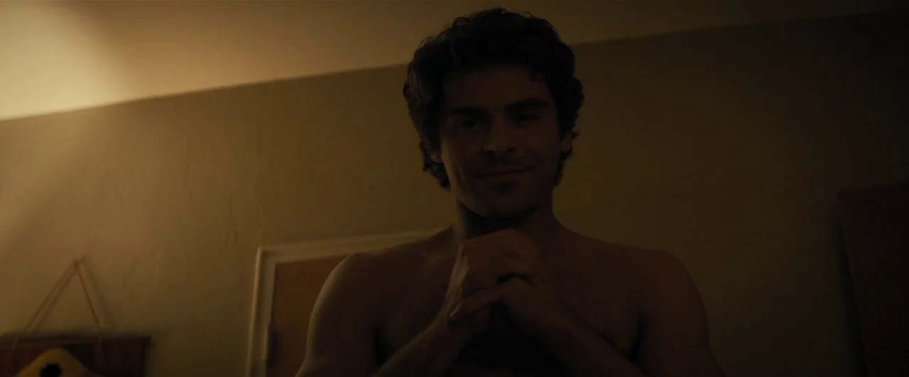 Extremely Wicked, Shockingly Evil and Vile (2019) movie still: medium — A dimly lit room with plain walls features a piece of decor in the…