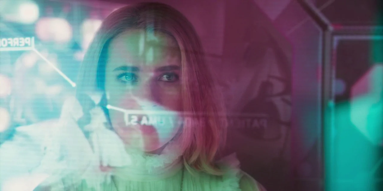 Paradise Hills (2019) movie still: closeup — A dimly lit interior space with a transparent glass surface displaying glowing digital text. A woman…