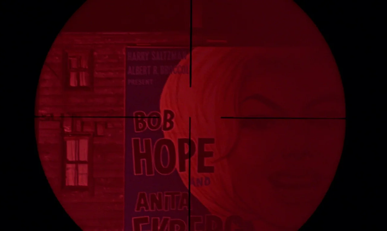 From Russia With Love (1963) movie still: medium — A brick building facade is visible through a sniper scope crosshair at night. A large promotional…