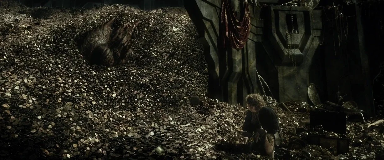 The Hobbit: The Desolation of Smaug (2013) movie still: wide — A vast cavern is filled with an enormous mountain of gold coins and artifacts. A…