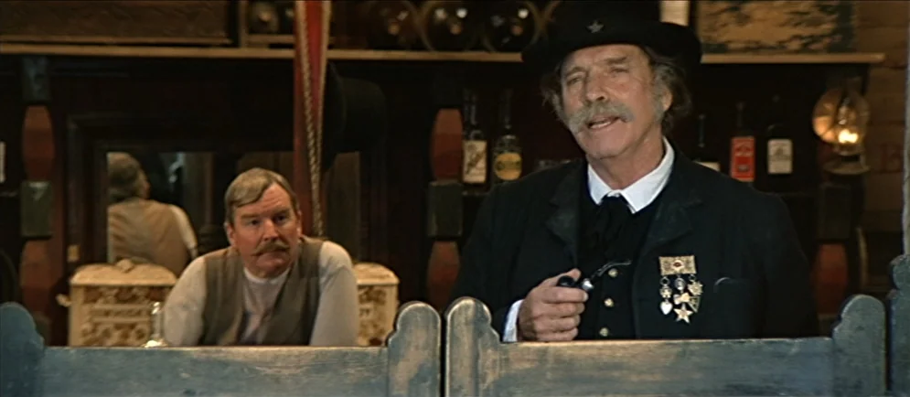 Buffalo Bill and the Indians, or Sitting Bull’s History Lesson (1976) movie still: medium — A rustic 19th-century western saloon features a dark…