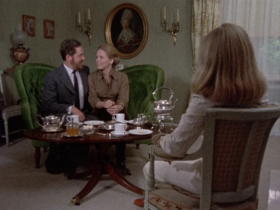 Scenes from a Marriage (1973) movie still: medium — A classic living room features olive green velvet furniture and an oval wall painting. Three…