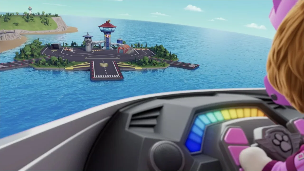 PAW Patrol: Air Rescue (2025) movie still: wide — An island base with a runway and command tower sits in the middle of water. A view from an…