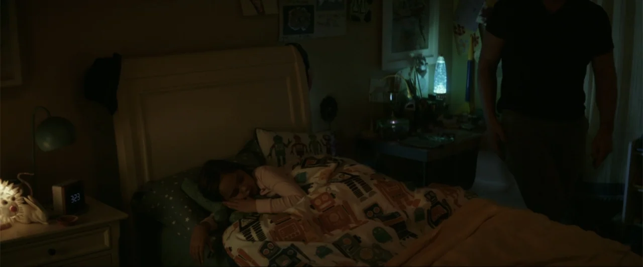 The Tomorrow War (2021) movie still: medium — A child's bedroom features a bed with robot-patterned bedding and assorted toys. A man in a dark…