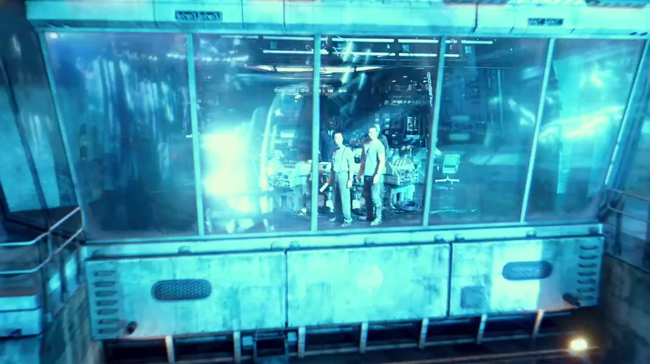Pacific Rim (2013) movie still: wide — A high-tech industrial control room is encased behind a large, slightly reflective glass partition. Three men…