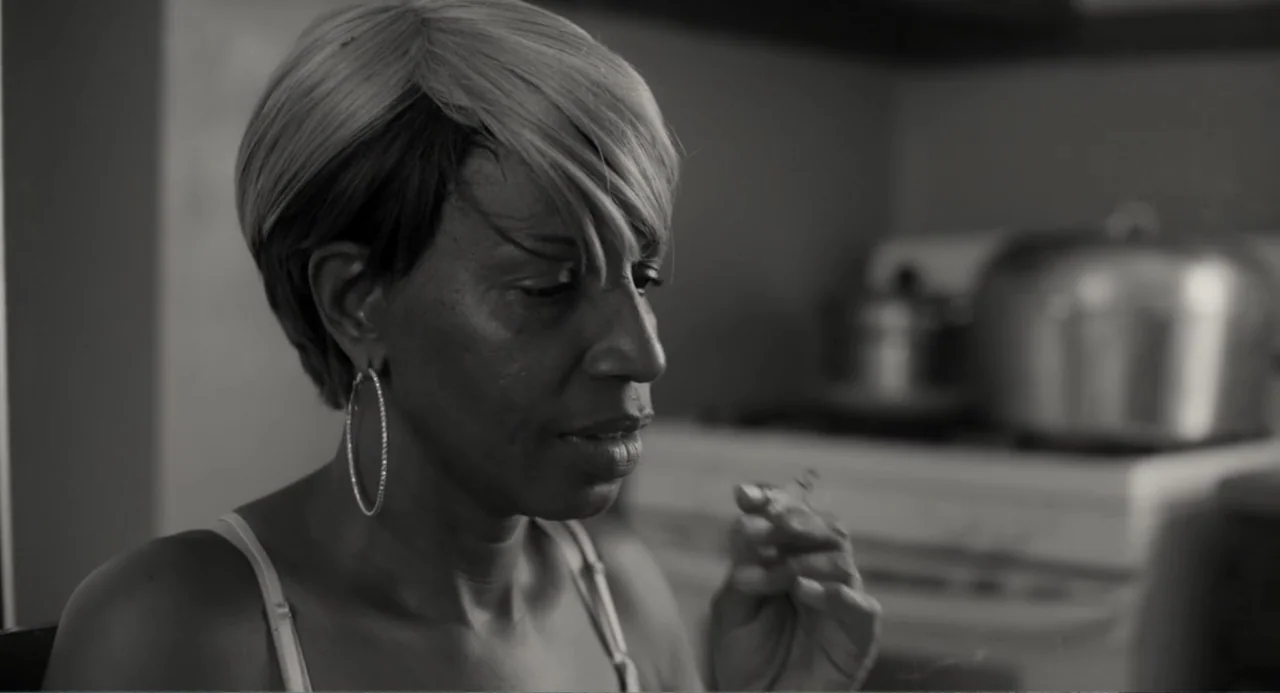 What You Gonna Do When the World's on Fire? (2019) movie still: closeup — A domestic kitchen space featuring a blurry stove top with a metal pot in…
