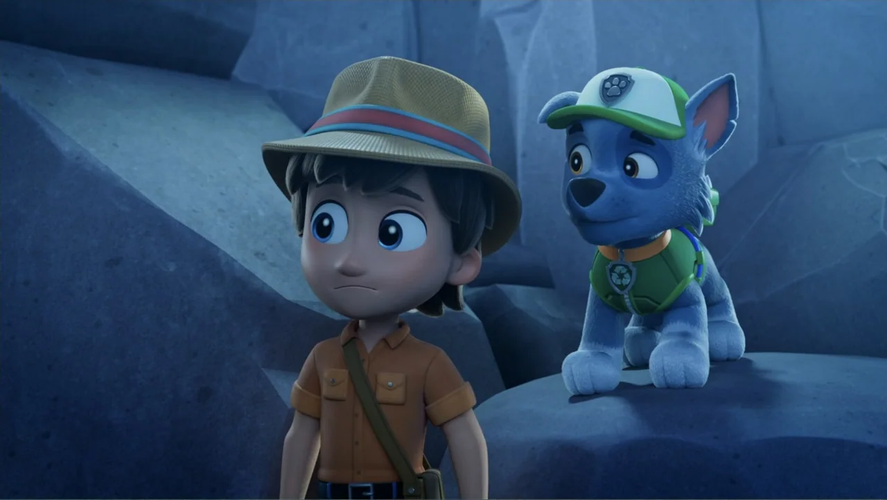 Valiente: A Tracker Story (2025) movie still: medium — A rocky, dimly lit outdoor area forms the backdrop for two animated figures. A young boy in a…