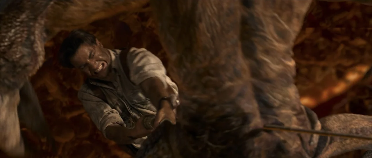 The Mummy Returns (2001) movie still: medium — A subterranean environment with rough textures and glowing embers in the blurry background. A man…