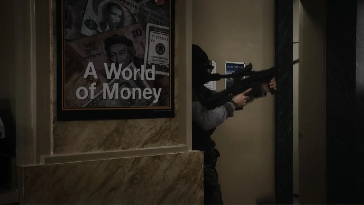Flypaper (1999) movie still: medium — An interior bank lobby features a wall poster about money near a doorway. A masked figure in tactical gear…